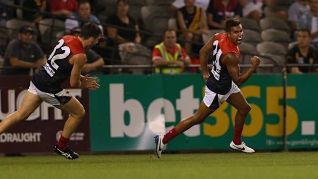 The sealer: Young Demon Jay Kennedy-Harris celebrates Melbourne's final goal in its thrilling victory over Richmond at Etihad Stadium on Friday night.