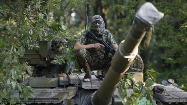 A pro-Russian separatist sits on a T-64 tank in Donetsk, eastern Ukraine on Wednesday.