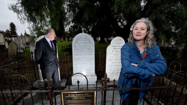 Diana Wolfe and CEO of City mission Reverend Ric Holland at the restored grave of Diana's great great grandfather John Singleton who was the founder of Citymission and The Royal Childrens Hospital.