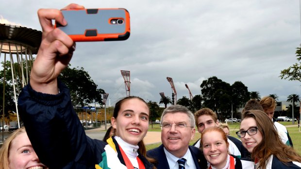 IOC president Thomas Bach at the Sydney Olympics site with members of the Australian fencing team getting a selfie.