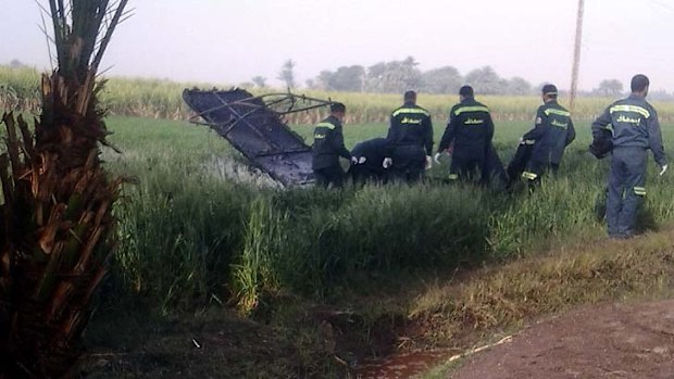 Rescue workers inspect the scene of a balloon crash outside al-Dhabaa village, south of Cairo, Egypt.