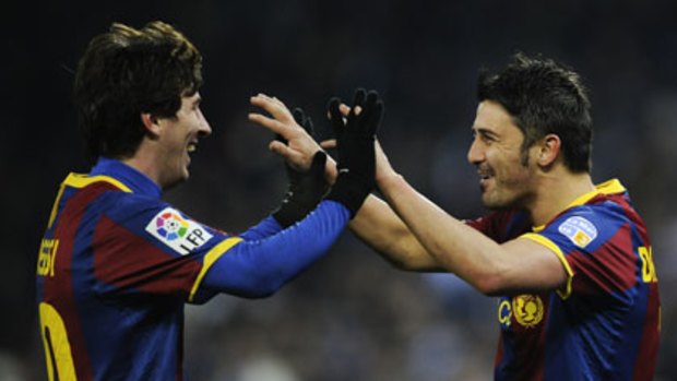 Little genius ... Lionel Messi, left, celebrates a goal against Espanyol earlier this month with Barcelona teammate David Villa.