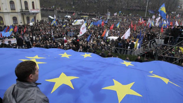 Demonstrators march and carry an EU flag during a protest in Kiev, Ukraine.