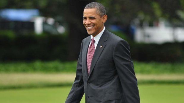 Something to smile about ... US President Barack Obama makes his way across the South Lawn of the White House.