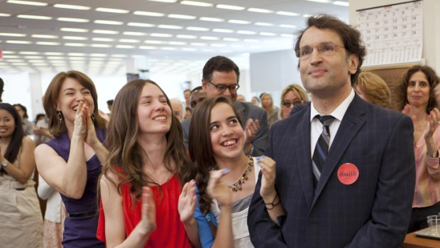 <i>New York Times</i> reporter David Kocieniewski receives a round of applause in the news room, while his daughters, Devin and Katia Barricklow, and his girlfriend, Audrey Gray (far left) look on.