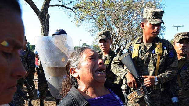 A woman cries while standing outside the prison.