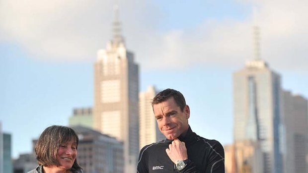 Cadel Evans and his mother Helen Cocks stroll by the Yarra yesterday. He will parade along St Kilda Road today.