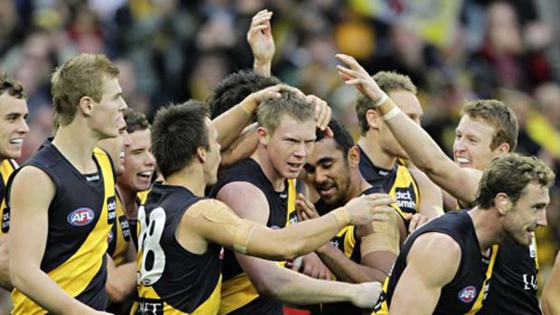 Jack Riewoldt (centre) is congratulated by his Richmond teammates after kicking 10 goals in the Tigers' win over West Coast yesterday.