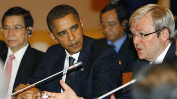 Barack Obama, left, listens Kevin Rudd at an APEC conference breakfast meeting.