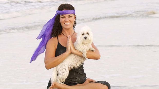 Doga instructor Suzi Teitelman and dog Roxy  in a cross-legged pose at Ponte Vedra Beach, Florida.