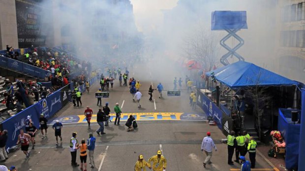 Smoke from one of the blasts clouds the finish line of the Boston Marathon.