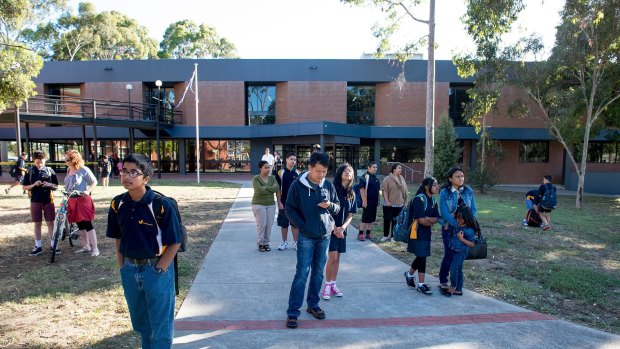 Costly provision: Students arriving for their first day at Coburg Junior High School in Melbourne on January 29 after community pressure led to the new school.