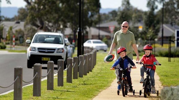 Alistair Reid with his sons Callum and Hamish in Mernda Villages. The family intends to move closer to the city.