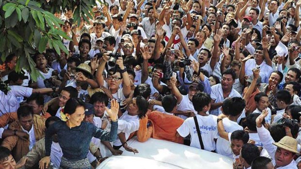 Hero’s welcome ... Aung San Suu Kyi is mobbed by supporters as she arrives at the National League for Democracy headquarters in Rangoon yesterday.