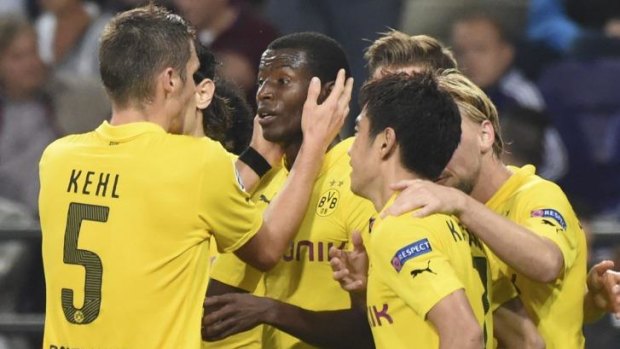 Dortmund players hug Adrian Ramos (centre) after he scored against Anderlecht.