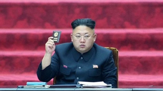 Throwing the book: North Korean leader Kim Jong-un in the Pyongyang parliament. The hermit state will try two US tourists for crimes against the state.