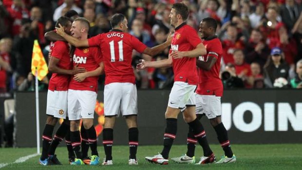 Festival of football: Manchester United players celebrate a goal at ANZ Stadium.