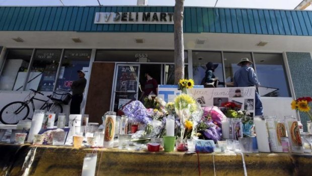 A makeshift memorial in front of the IV Deli Mart, one of the scenes of the mass shooting.