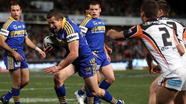 Jordan Atkins of the Eels makes a break on his way to score a try.