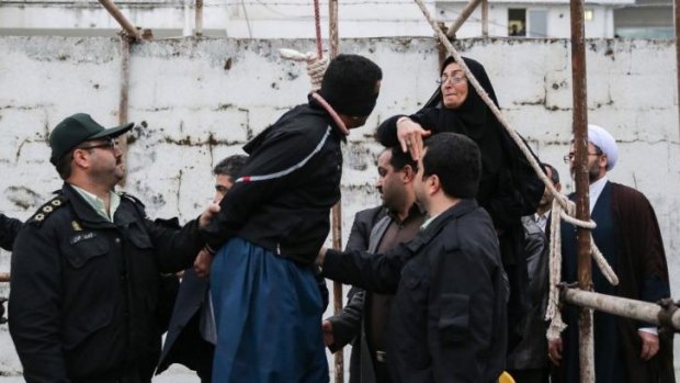 Saved by a slap ... Samereh Alinejad (right) hits Balal, who killed her son, during an execution ceremony in the northern city of Nowshahr, Iran.