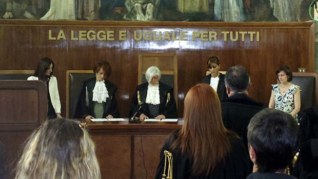 Judge Anna Maria Gatto, centre, reads the sentence at the Milan court.