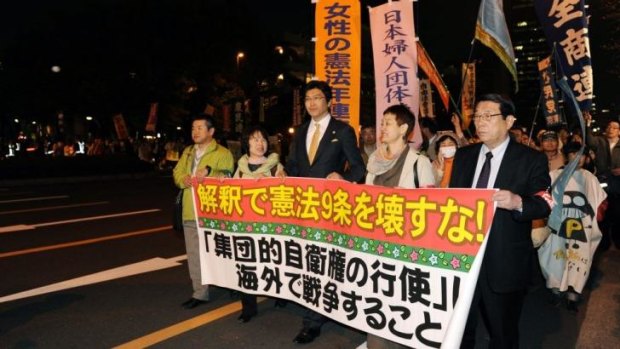 Demonstrators march against plans to soften Japan's constitutional commitment to pacifism.