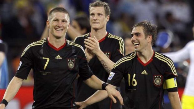 Star man ... Germany's Bastian Schweinsteiger, left, celebrates with  Marcell Jansen, centre, and Philipp Lahm.