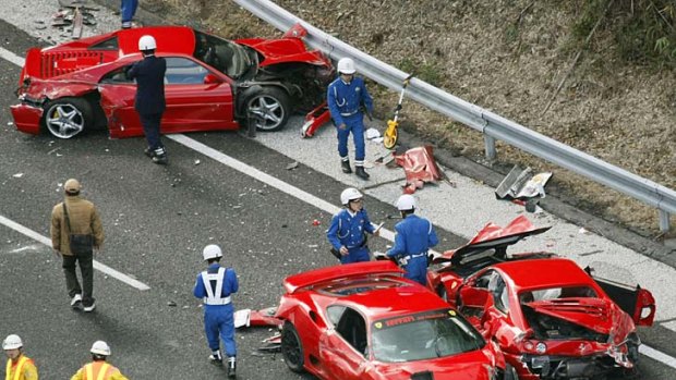 Crash ... police officers examine three damaged Ferraris.