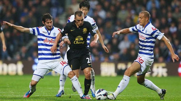 Everton's Leon Osman battles with a host of Queens Park Rangers opponents.