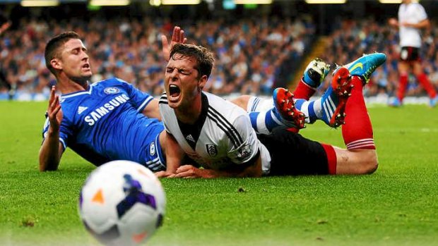 Collision: Gary Cahill (L) of Chelsea challenges Scott Parker of Fulham.