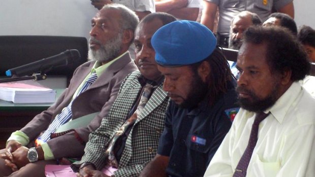 Forkorus Yaboisembut (left) and three other defendants in court.