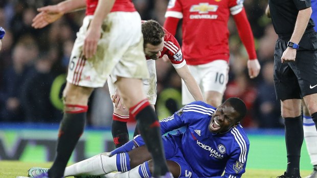 Huge blow: Chelsea's Kurt Zouma clutches his knee after tearing his ACL.