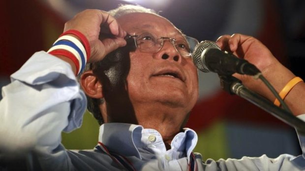 Thai protest leader Suthep Thuagsuban adjusts his glasses while making a speech during an anti-government rally outside the government complex on the outskirts of Bangkok.