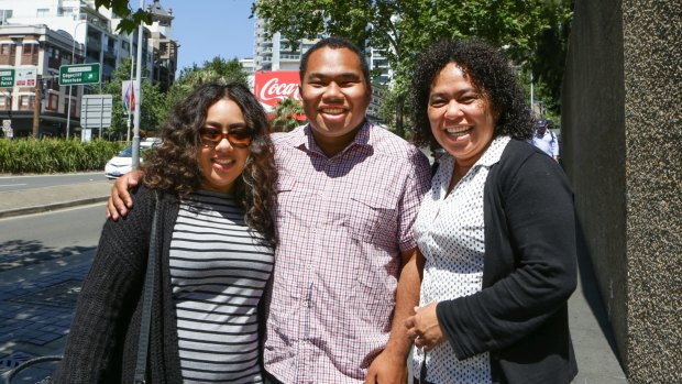 Chris Lee with sister Olivia (left) and mother Milli at the site of his stabbing in William Street.