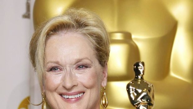 Meryl Streep with her latest speaking engagement prop ... her Best Actress Oscar for The Iron Lady.