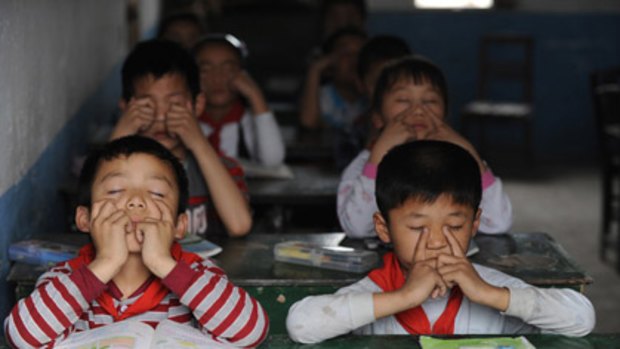 Eyes wide shut...children at an elementary school in Hefel, Anhui province. Schools are now guarded by police, including some carrying sub-machine guns.