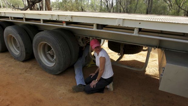 Protest: Coonamble farmer Ted Borowski locks himself onto the axle of a heavy articulated vehicle, bringing a Santos convoy to a standstill in the Pilliga State Forest.