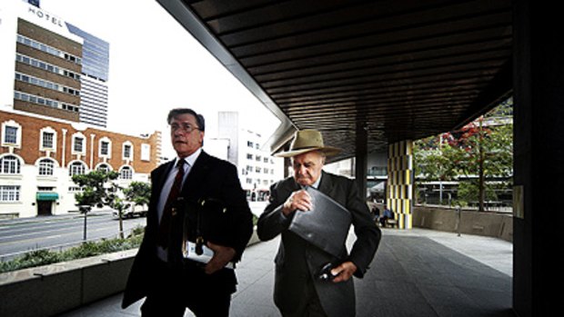 Rex Crane leaves the Brisbane Magistrates Court with his lawyer.