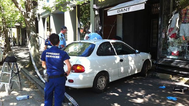 Police investigate after a ram-raid at the Gant store in Woollahra on Tuesday.