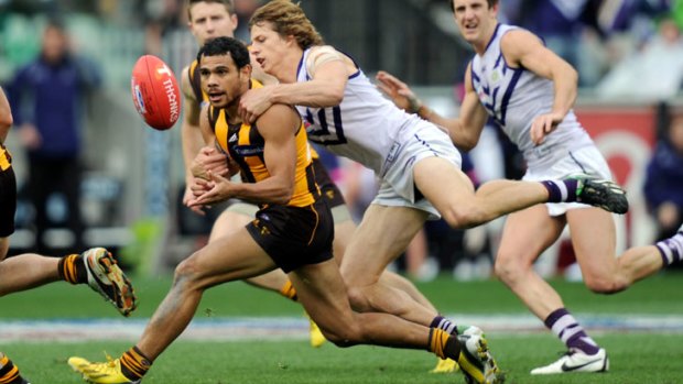 Hawthorn's Cyril Rioli chased by Fremantle's Nathan Fyfe at the 2013 AFL grand final.