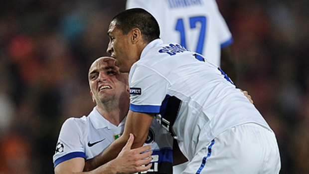 Inter Milan's Ivan Cordoba and Esteban Cambiasso celebrate their win over Barcelona, securing them a place in the Champions League semi-final.