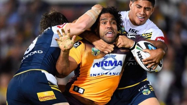 Sam Thaiday of the Broncos is tackled by Jason Taumalolo and Rory Kostjasyn of the Cowboys.
