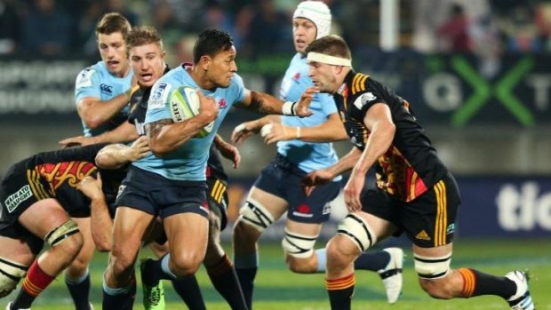 Tough competitor: Israel Folau palms off a Chiefs defender.