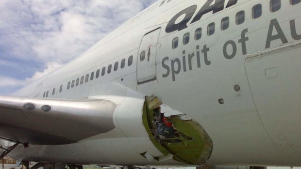 Emergency landing: A Qantas jumbo shows its damaged fuselage in Manila in July 2008.