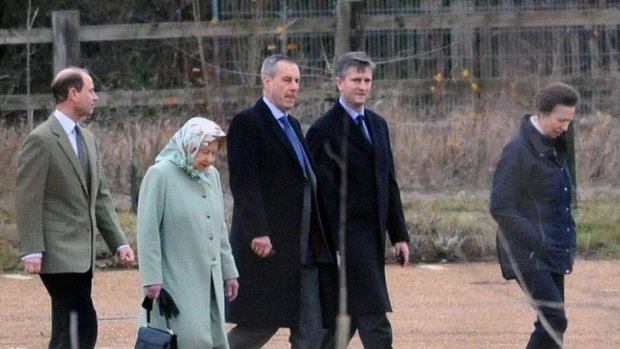 Britain's Queen Elizabeth is accompanied by her youngest son Edward (above left) daughter Anne (above right) and a pair of security officers after arriving by helicopter at Papworth Hospital to visit her husband Prince Philip.