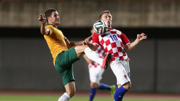 Australia's Matthew Leckie and Luka Modric, of Croatia, contest the ball during Friday night's friendly at Pituacu Stadium in Salvador, Brazil.  
