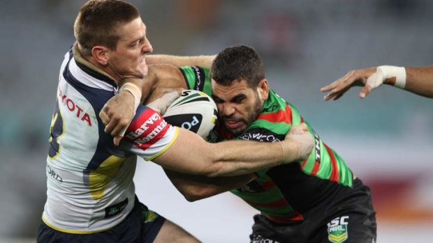 Too hot to handle: Brent Tate tries to get a handle on Greg Inglis in last night's clash at ANZ Stadium.