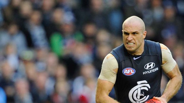 Chris Judd steps on the gas and leaves Swan Ted Richards in his wake.