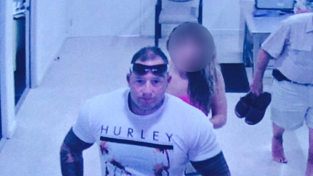 Surveillance photo of Joshua Faulkhead, in white shirt with sunnies and tatts, boarding a plane to Sydney.