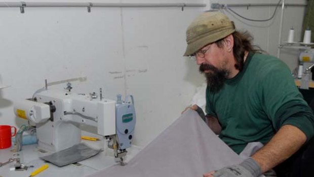 All sewn up ...  a prisoner in Bathurst jail makes quilt covers for charity.